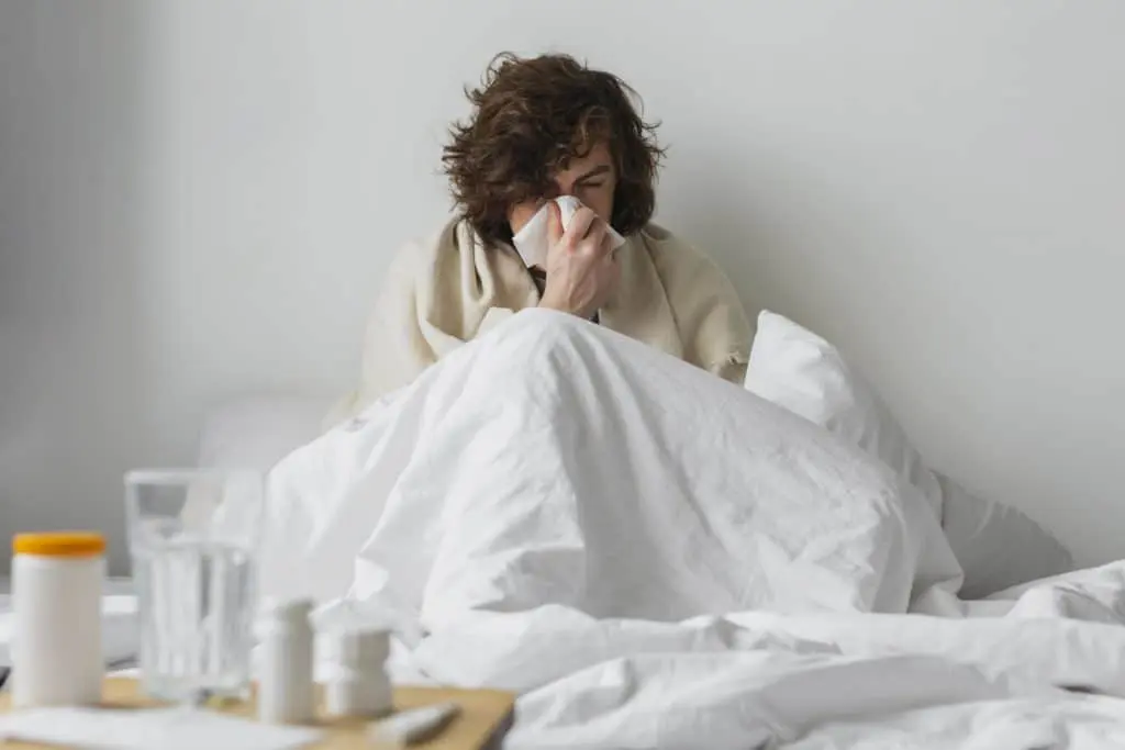 Free photo young sick man staying in his bed